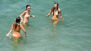 Three young girls bathe in the sea beautiful tits and pussy